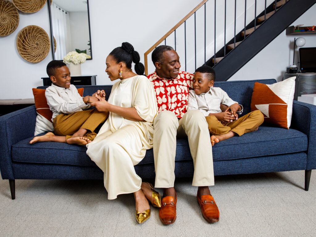 Family of four enjoying holiday moments in cozy Brooklyn apartment living room