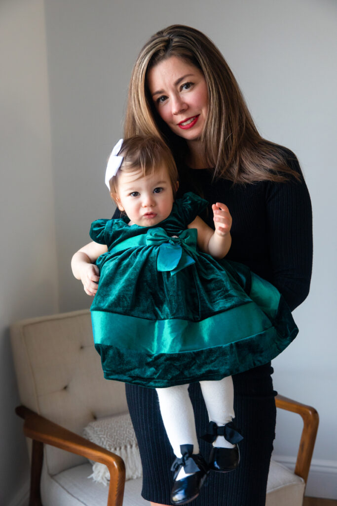 First-time parents sharing holiday moments with toddler in Long Island Home