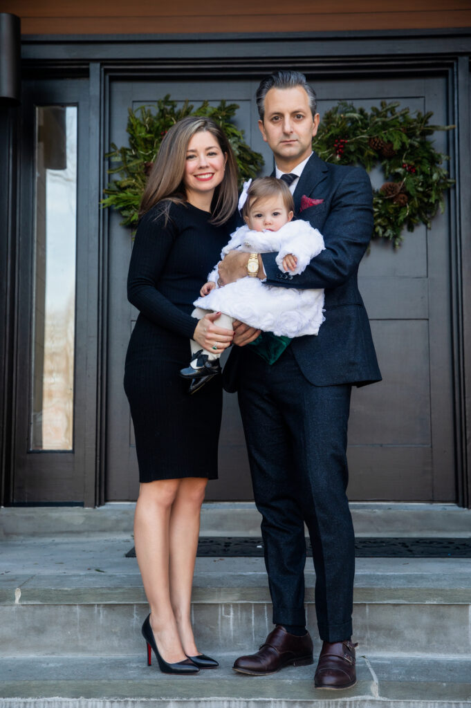 First-time parents sharing holiday moments with toddler in Long Island Home