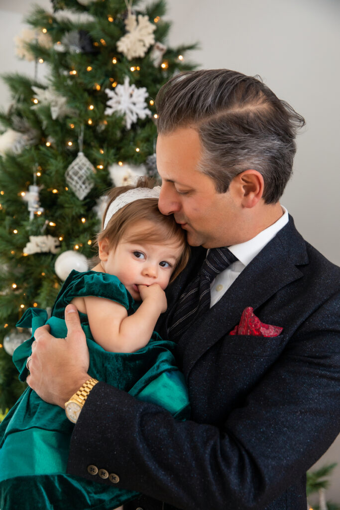 First-time parents sharing holiday moments with toddler in Long Island Home